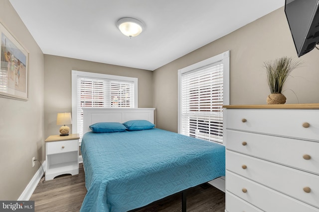 bedroom featuring dark wood-type flooring and baseboards