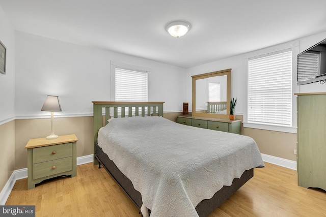 bedroom featuring light wood-type flooring and multiple windows