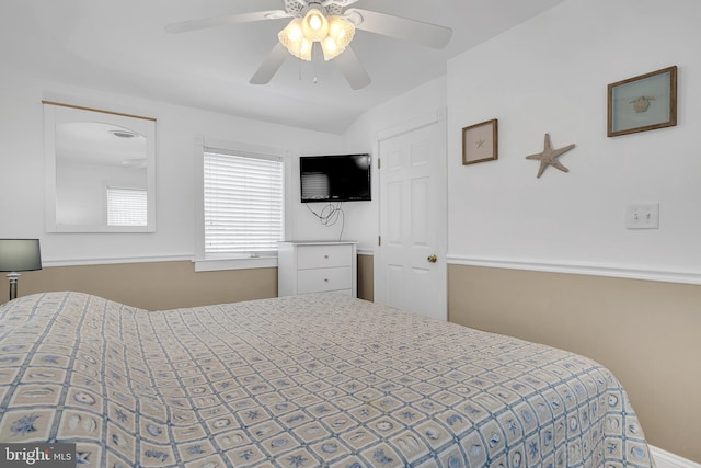 bedroom with a ceiling fan and vaulted ceiling