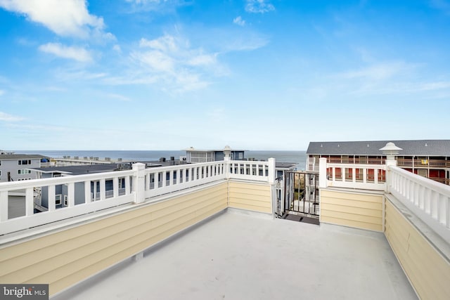 view of patio with a balcony and a water view