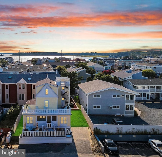 aerial view at dusk featuring a residential view