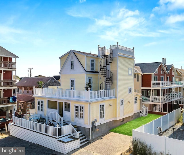 rear view of property featuring a balcony