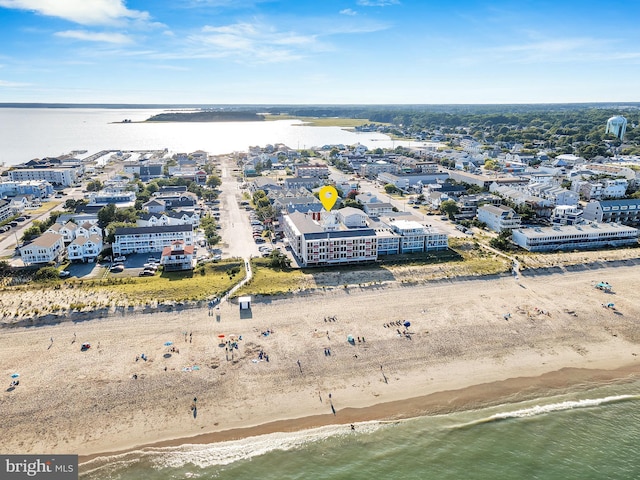 birds eye view of property featuring a water view and a beach view