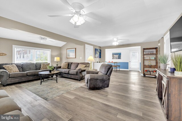 living room featuring ceiling fan and light hardwood / wood-style flooring