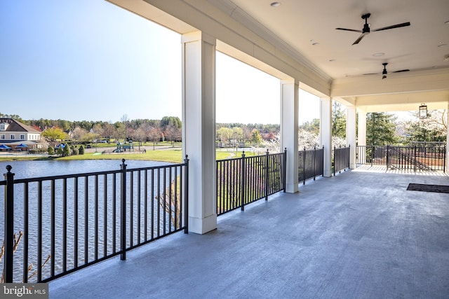 view of patio / terrace featuring a water view and ceiling fan