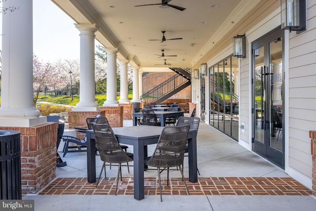 view of patio / terrace featuring stairway, ceiling fan, and outdoor dining space