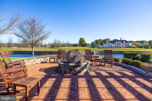 view of patio / terrace with a water view and an outdoor fire pit