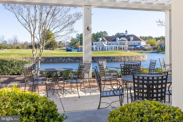 view of patio / terrace with outdoor dining area and a water view