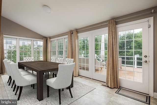 dining area with lofted ceiling and a wealth of natural light