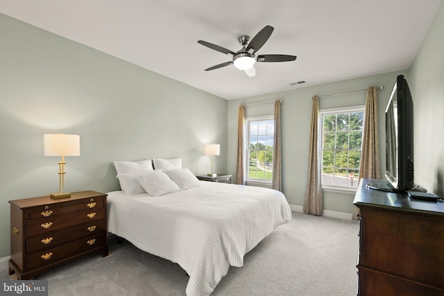 carpeted bedroom featuring visible vents, a ceiling fan, and baseboards