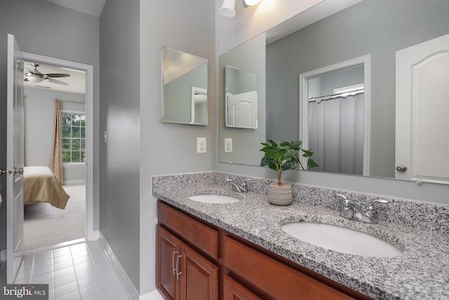 bathroom featuring a ceiling fan, tile patterned floors, double vanity, and a sink