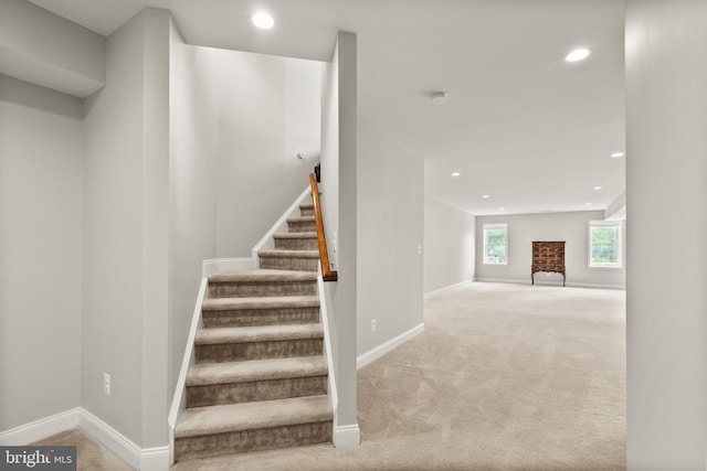 stairway with recessed lighting, baseboards, carpet, and a brick fireplace