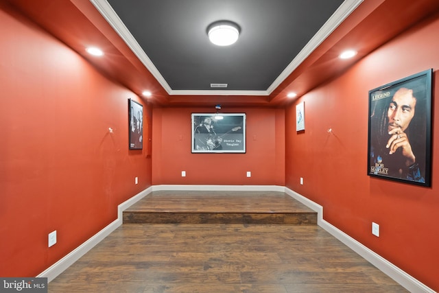 home theater room featuring recessed lighting, crown molding, baseboards, and wood finished floors