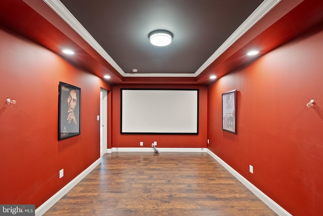 home theater room featuring recessed lighting, ornamental molding, baseboards, and wood finished floors