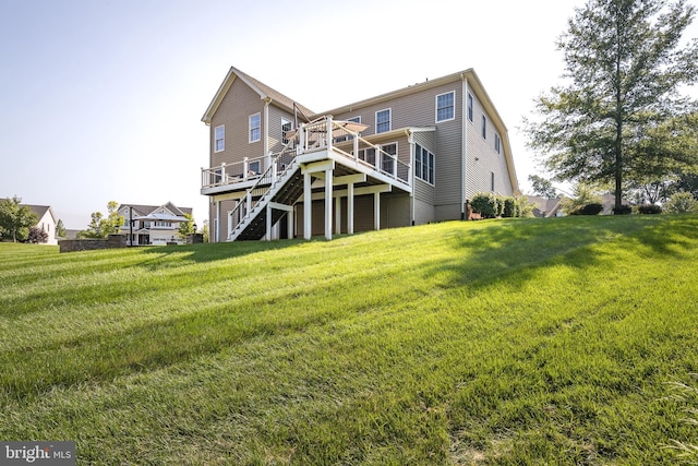 back of property with stairway, a lawn, and a wooden deck