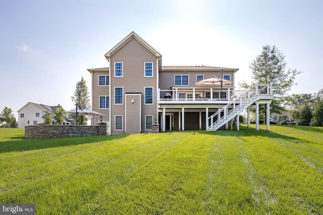 rear view of property featuring a wooden deck, a lawn, and stairs