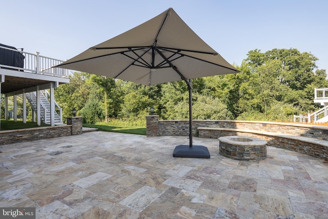 view of patio with stairway, a fire pit, and a wooden deck