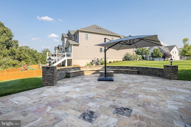 view of patio featuring fence, an outdoor fire pit, and a playground