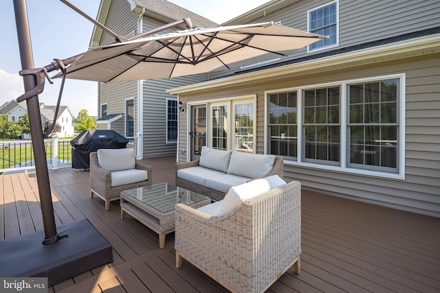 deck with a grill and an outdoor hangout area