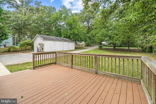 wooden deck featuring a lawn and a shed