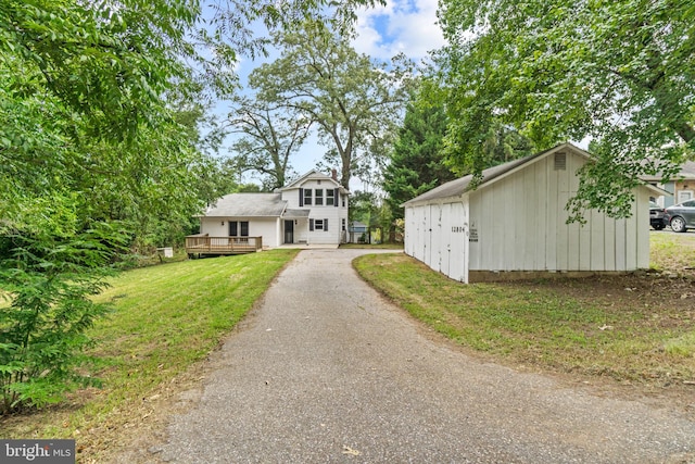 view of front of home featuring a deck and a front yard