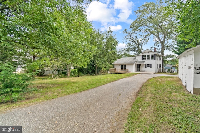 exterior space with a front lawn and a deck