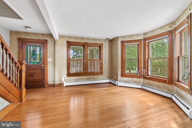 entrance foyer with light hardwood / wood-style flooring, beamed ceiling, and a baseboard radiator