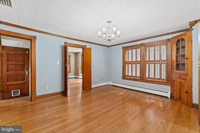 unfurnished room with a notable chandelier, light hardwood / wood-style flooring, a baseboard heating unit, and ornamental molding