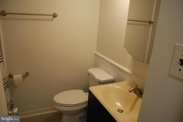 bathroom featuring vanity, toilet, and tile patterned flooring