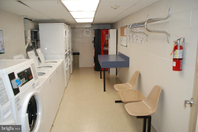 laundry room with stacked washer / drying machine and washer and clothes dryer