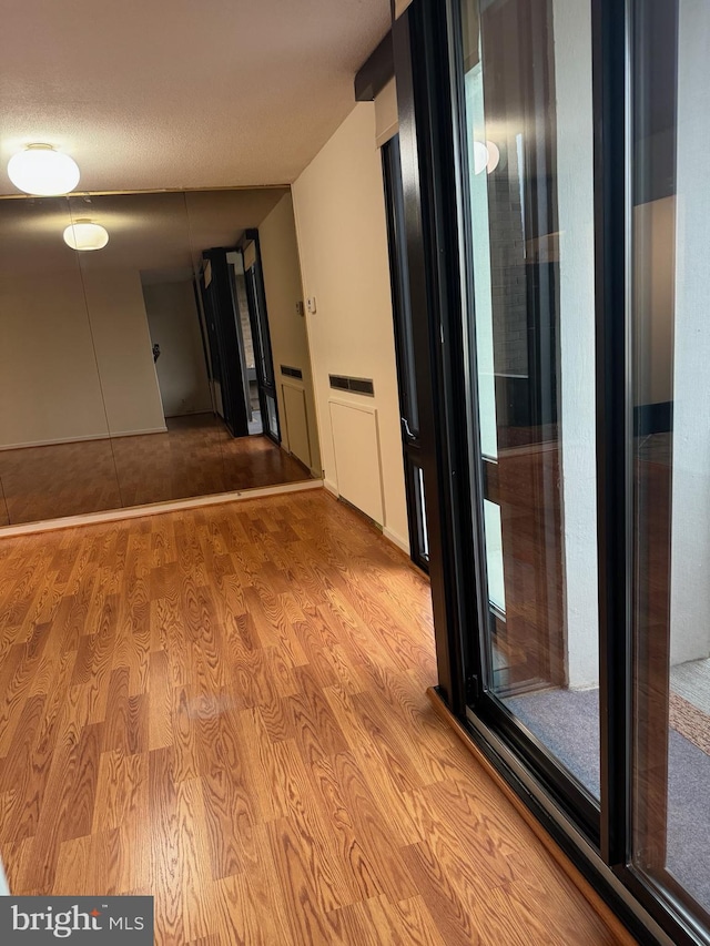 hall with light hardwood / wood-style floors