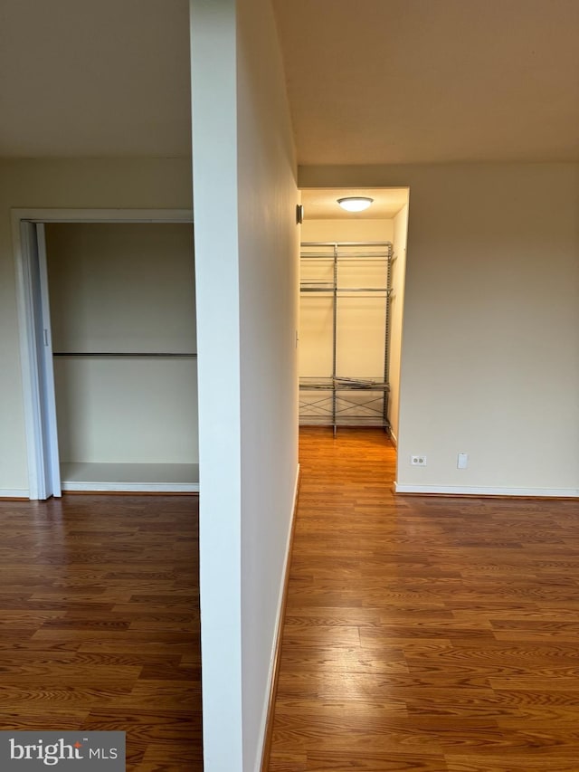 hall with wood-type flooring