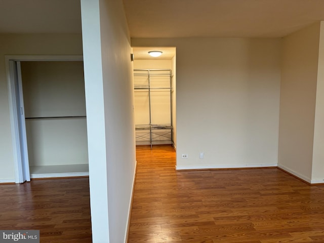 corridor with hardwood / wood-style floors