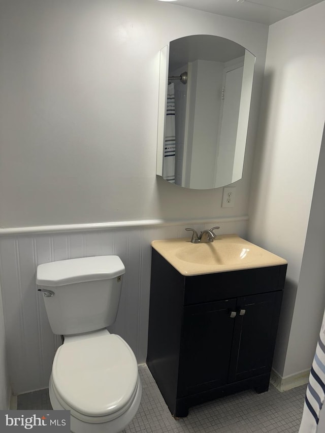 bathroom with vanity, toilet, and tile patterned flooring