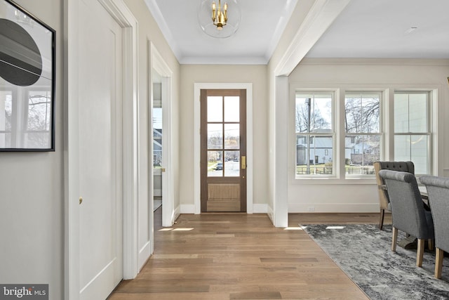 entryway with crown molding and hardwood / wood-style flooring