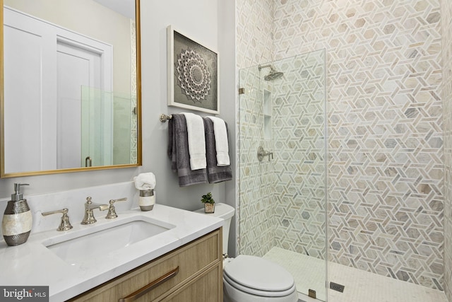 bathroom with an enclosed shower, toilet, and vanity