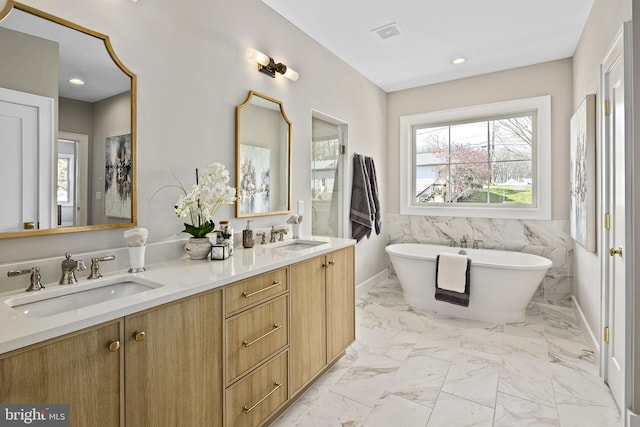 bathroom with vanity, tile walls, and a bathing tub