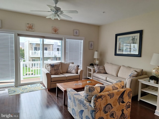 living room featuring ceiling fan and dark hardwood / wood-style flooring