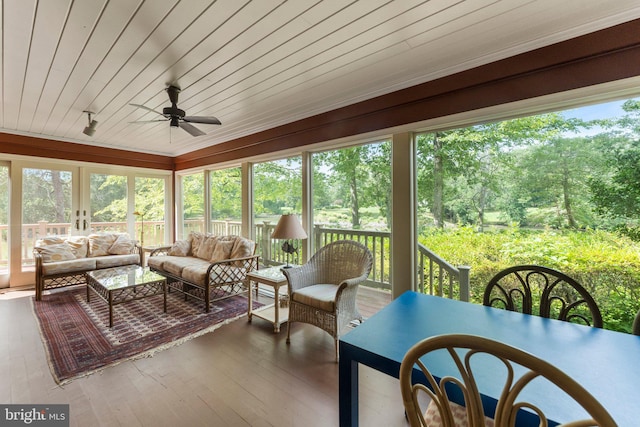 sunroom with wood ceiling, ceiling fan, and a healthy amount of sunlight