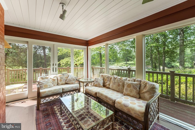 sunroom / solarium featuring wood ceiling