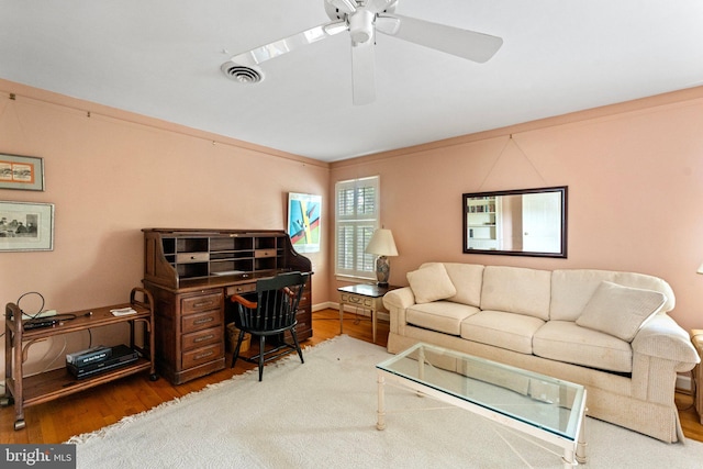 home office with hardwood / wood-style flooring and ceiling fan