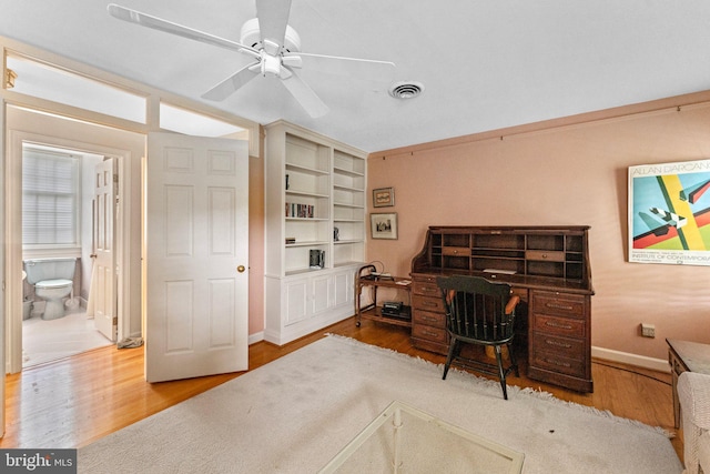 office space with light wood-type flooring and ceiling fan