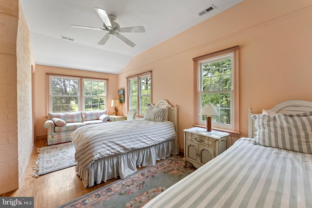 bedroom featuring vaulted ceiling, hardwood / wood-style floors, and ceiling fan