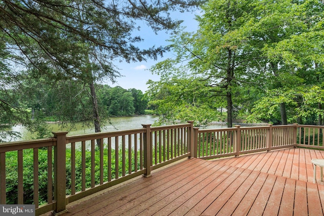 wooden terrace featuring a water view