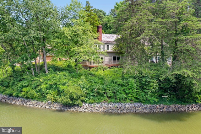 rear view of house featuring a water view