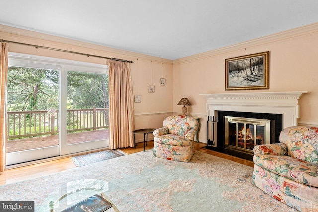 living room featuring light hardwood / wood-style floors and ornamental molding