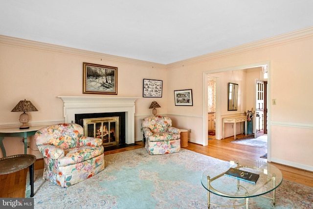 living room featuring crown molding and light hardwood / wood-style flooring