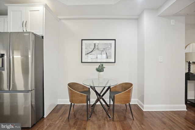 dining area featuring dark wood-type flooring