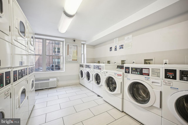 washroom with stacked washer / drying machine, light tile patterned floors, and washer and dryer