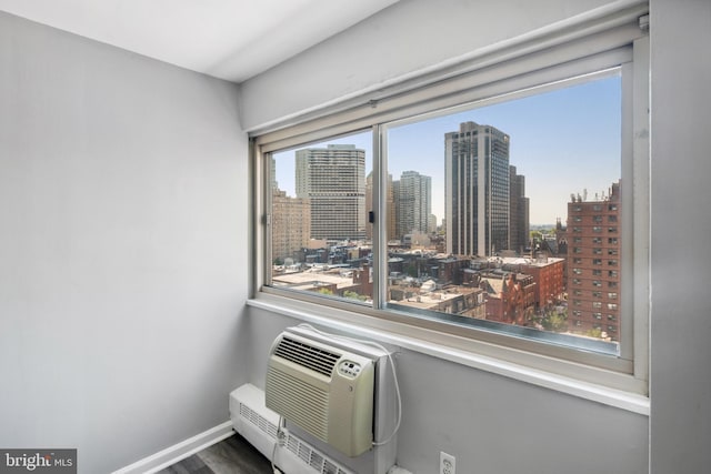 details featuring an AC wall unit and hardwood / wood-style floors